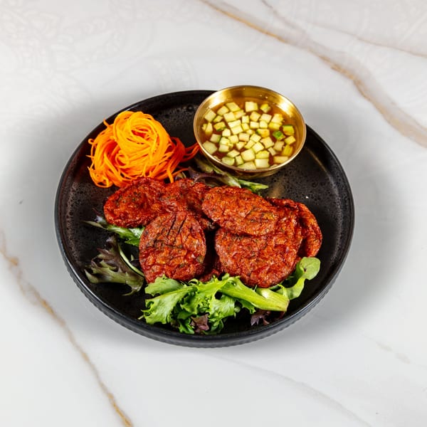 Phirom Thai Restaurant's fish cakes with shredded carrots, lettuce, and cucumber dipping sauce.