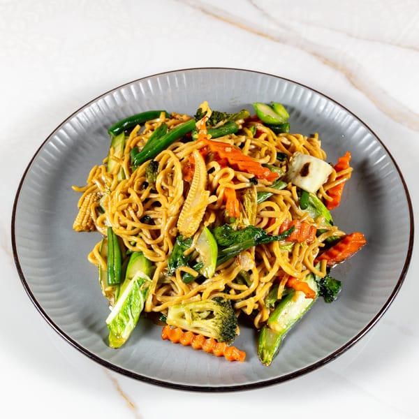 Close-up of Phirom Thai Restaurant's Pad See Ew with noodles, broccoli, carrots, and baby corn.