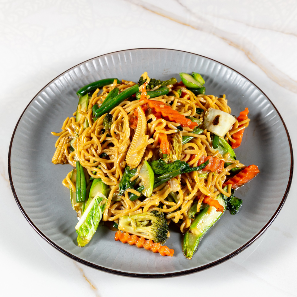 Close-up of Phirom Thai Restaurant's Pad See Ew with noodles, broccoli, carrots, and baby corn.