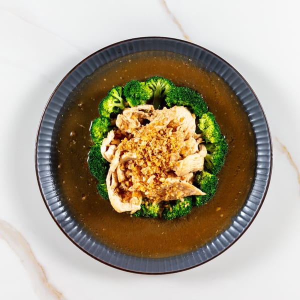 Phirom Thai Restaurant's chicken with garlic sauce and broccoli on a dark plate.